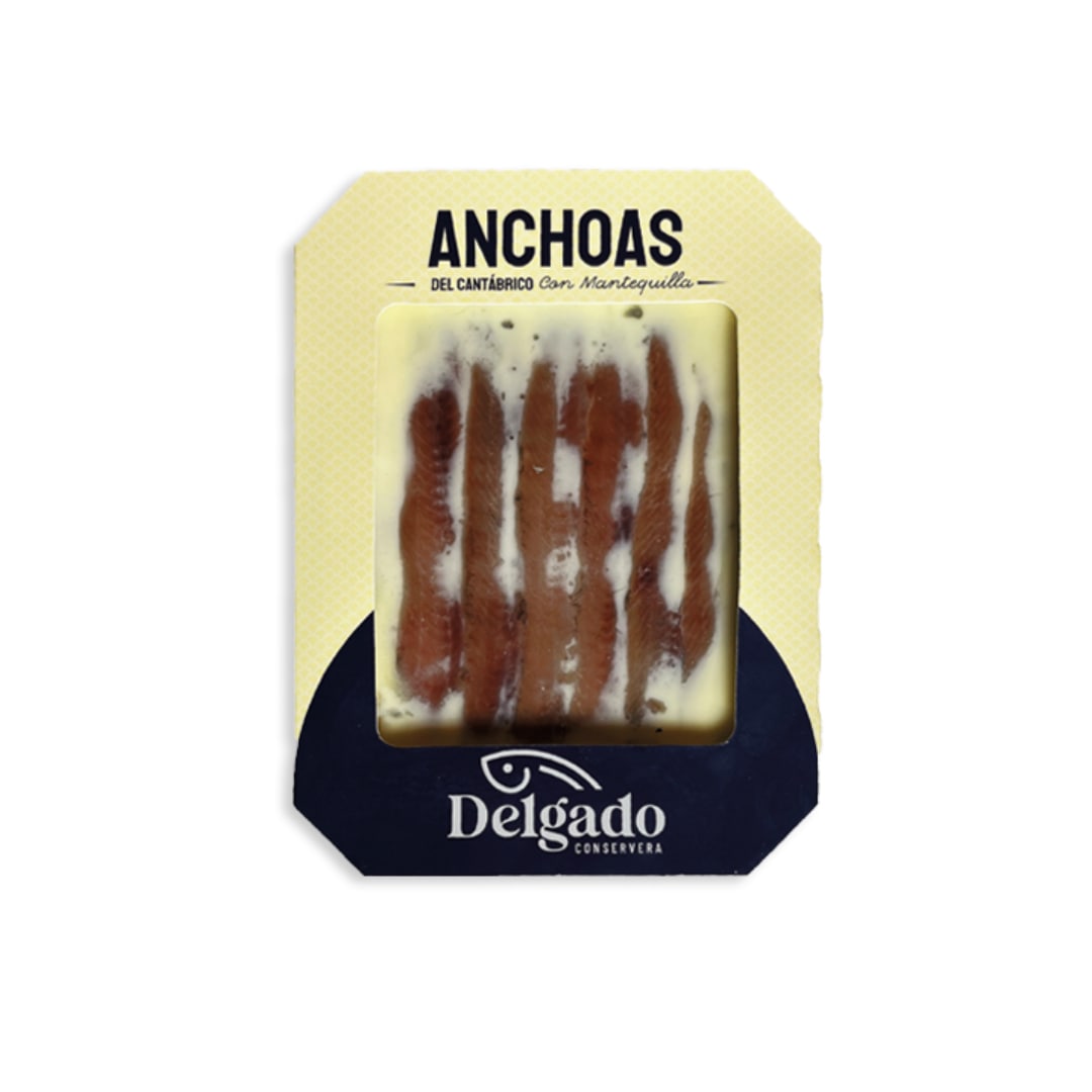 Packaged Cantabrian anchovies preserved in butter, branded by Delgado, with a white and blue label.