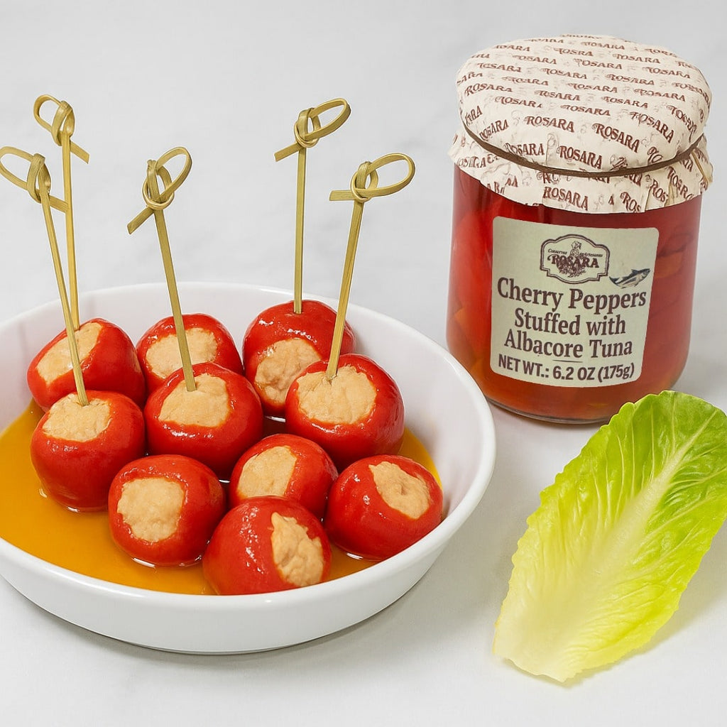 Stuffed cherry peppers with a jar of Rosana Cherry Peppers Stuffed with Albacore Tuna on a white background.